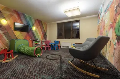 a waiting room with a chair and colorful chairs at Ores Boutique Hotel in Bansko