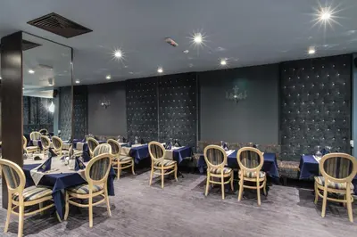 a dining room with blue tables and chairs at Ores Boutique Hotel in Bansko