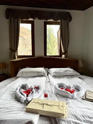 a bed with two baskets with hearts on it at Къща за гости Родопски изгрев in Leshten