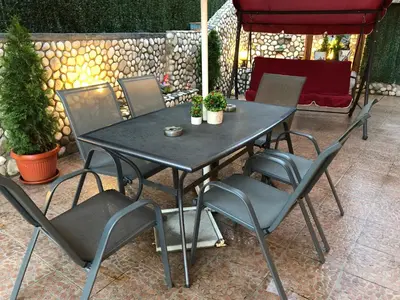 a black table and chairs on a patio at Стаи за Гости Тони и Крис in Devin