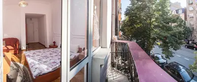 two views of a room with a bed and a window at Sofia Apartment in House 8 boulevard Hristo Botev in Sofia