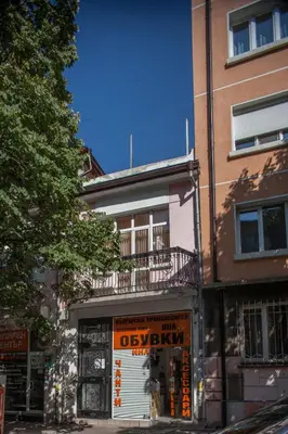 a building with an orange sign on the side of it at Sofia Apartment in House 8 boulevard Hristo Botev in Sofia