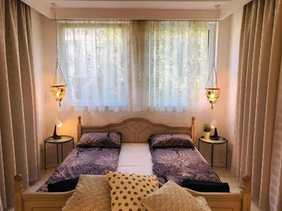 a bedroom with two beds in front of a window at Golden Pearl - jacuzzi top center luxury apartment in Sofia