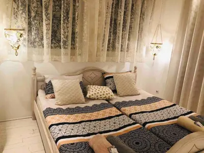 a bedroom with a bed with pillows and curtains at Golden Pearl - jacuzzi top center luxury apartment in Sofia