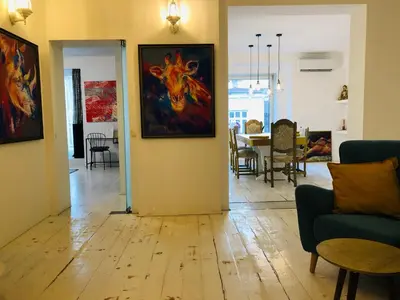 a living room with a painting on the wall at Golden Pearl - jacuzzi top center luxury apartment in Sofia