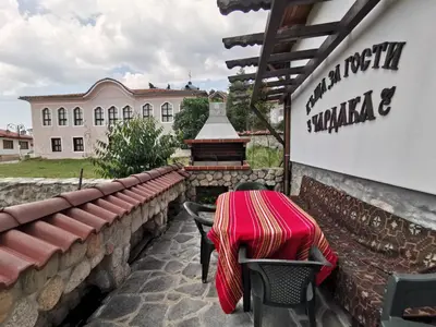 a table and chairs sitting outside of a building at Възрожденски комплекс Чардакъ Сопот in Sopot
