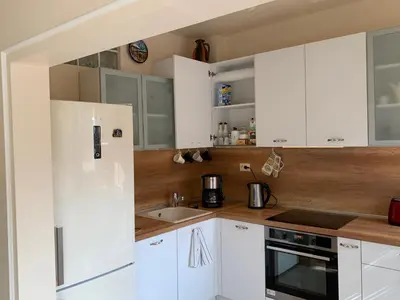 a kitchen with white cabinets and a sink at ViITOSHKA Apartment in Sofia