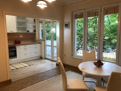 a kitchen and dining room with a table and chairs at ViITOSHKA Apartment in Sofia