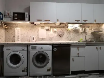 a kitchen with two washing machines and a counter at PIJAMA HOUSE - Bike & Bed in Plovdiv