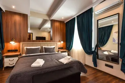 a bedroom with a large bed and a large mirror at Palace of Culture 2-Bedroom Retreat on Skobelev blvd in Sofia
