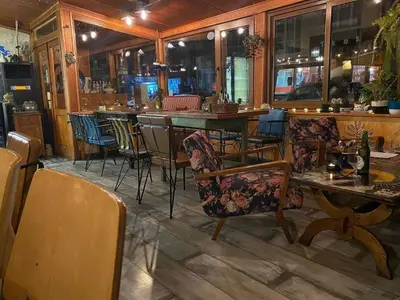 a restaurant with chairs and a table and a bar at Palace of Culture 2-Bedroom Retreat on Skobelev blvd in Sofia