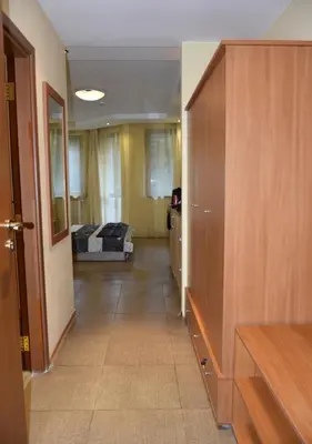 a hallway of a room with a bed in the distance at Studio Villa Park Premium in Borovets