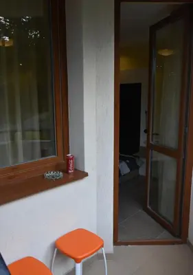 a room with an orange stool and a window at Studio Villa Park Premium in Borovets