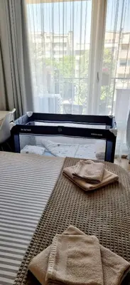 a bed with two towels on it in a room with a window at Plovdiv City Center Kapana with garage in Plovdiv