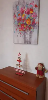 a dresser with a christmas tree on top of it at Snow magic Grand Monastery in Pamporovo