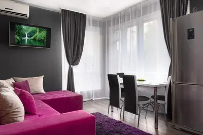 a living room with a pink couch and a table at VITOSHKA Pleasure place in Sofia