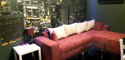 a couch in a room with a view of a city at VITOSHKA Pleasure place in Sofia