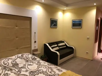 a bedroom with a bed and a chair in it at Studio Villa Park Premium Gold in Borovets