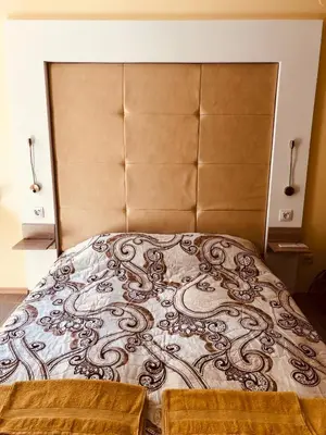 a large bed with a large headboard in a bedroom at Studio Villa Park Premium Gold in Borovets
