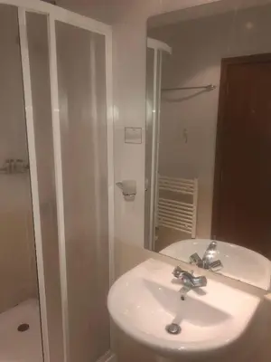 a bathroom with a sink and a shower and a mirror at Studios -Villa Park SV in Borovets