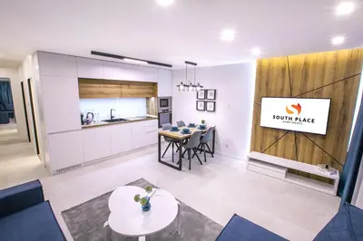 a kitchen and dining room with a table in a room at South Place Apartments in Sandanski