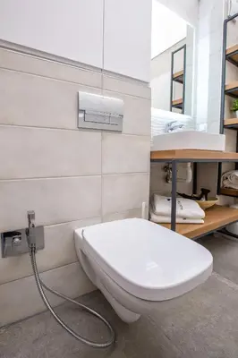 a bathroom with a white toilet and a sink at South Place Apartments in Sandanski