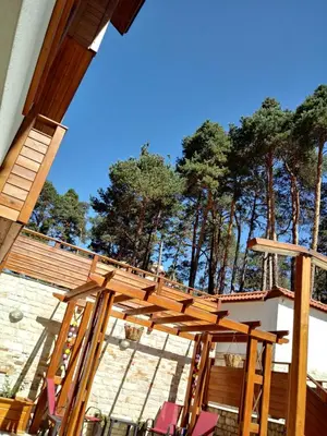 a wooden pergola on top of a house at Апартамент Allegri Padrini Комплекс Вели Хилс in Velingrad