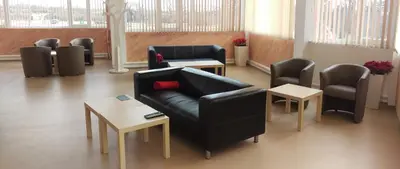 a waiting room with a couch and chairs and tables at Апартаментен туристически комплекс Аква Терми in Krasnovo