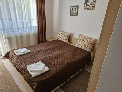 a bedroom with a bed with two towels on it at Apartments in Borovets Gardens in Borovets