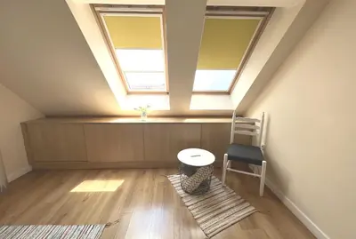 a room with a table and a chair and two windows at Unique Luxurious Jacuzzi PENTHOUSE DUPLEX in City Center! 2 BATHS! FREE PARKING! in Sofia