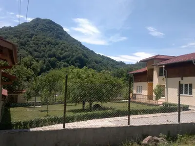 a chain link fence in front of a mountain at Villa Nanevi in Teteven