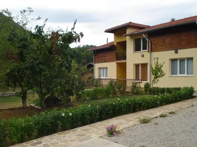 a house with a garden next to a street at Villa Nanevi in Teteven