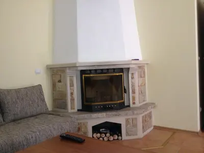 a fireplace with a television in a living room at Ski Apartment in Castle Complex in Pamporovo