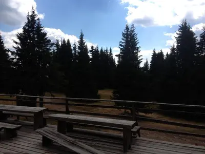 two wooden benches sitting on a wooden deck at Ski Apartment in Castle Complex in Pamporovo