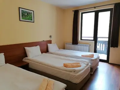 a hotel room with two beds and a window at Rusaliite Adventure House in Bachevo