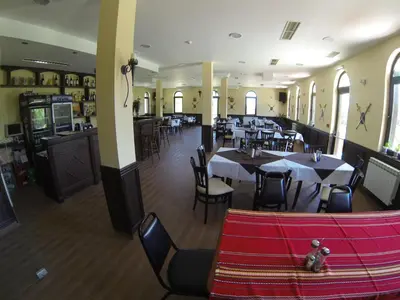 a dining room with tables and chairs in a restaurant at Rusaliite Adventure House in Bachevo