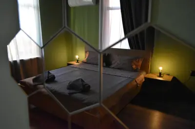 a bedroom with a bed with two candles on it at Art Apartment 36 in Plovdiv