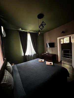 a bedroom with a large bed and a window at Art Apartment 36 in Plovdiv