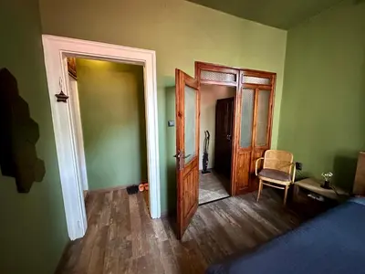 a room with green walls and an open door at Art Apartment 36 in Plovdiv