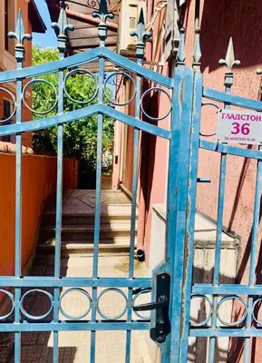 a blue gate in front of a building at Art Apartment 36 in Plovdiv