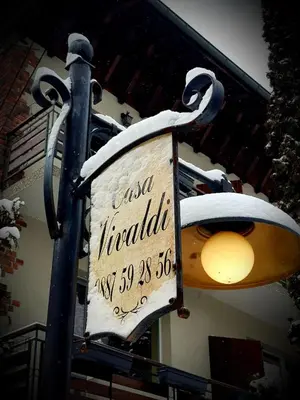 a sign on a street light with snow on it at Casa Vivaldi in Velingrad