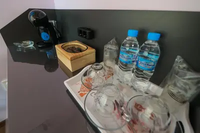 a group of bottles of water on a table with glasses at Family Hotel Gotse Delchev in Gotse Delchev