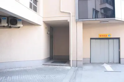 a building with a door with a sign on it at Central Square Apartment in Plovdiv
