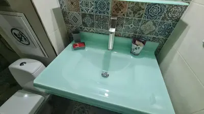 a bathroom with a blue sink and a toilet at Art House Plovdiv in Plovdiv