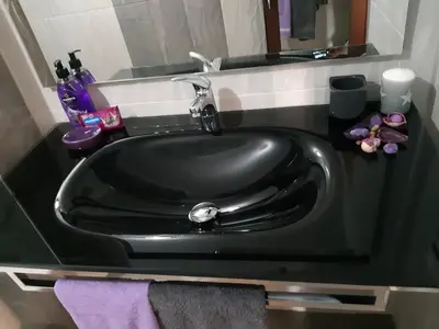 a black sink in a bathroom with a purple towel at Art House Plovdiv in Plovdiv