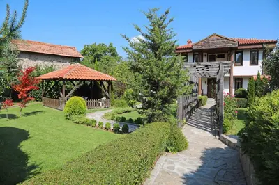 a house with a garden with a gazebo at guest house Margarita in Bryagovo