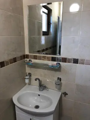 a bathroom with a sink and a mirror at Vila Rila in Sapareva Banya