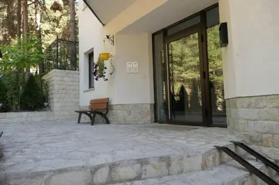 a patio with a bench in front of a building at Апартамент Мия Deluxe in Velingrad