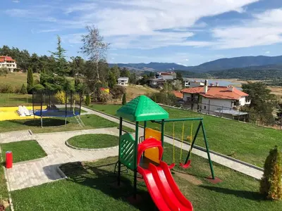 a playground with a slide in a park at Katalina Resort in Tsigov Chark