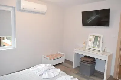 a bedroom with a bed and a tv on a wall at SWEET HOME PLOVDIV in Plovdiv